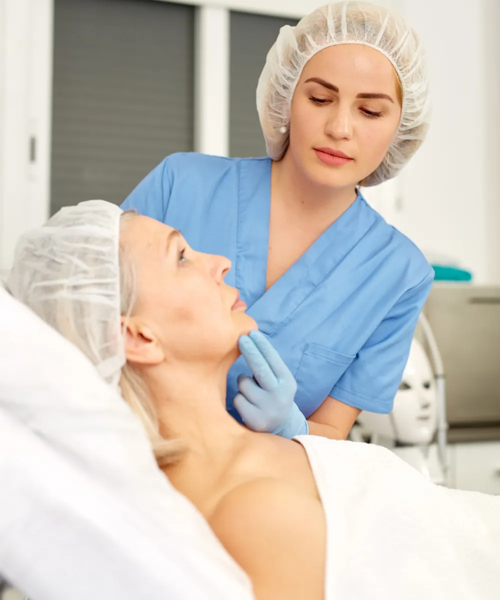 A plastic surgery consultation room where a patient and surgeon review digital marketing results on a tablet